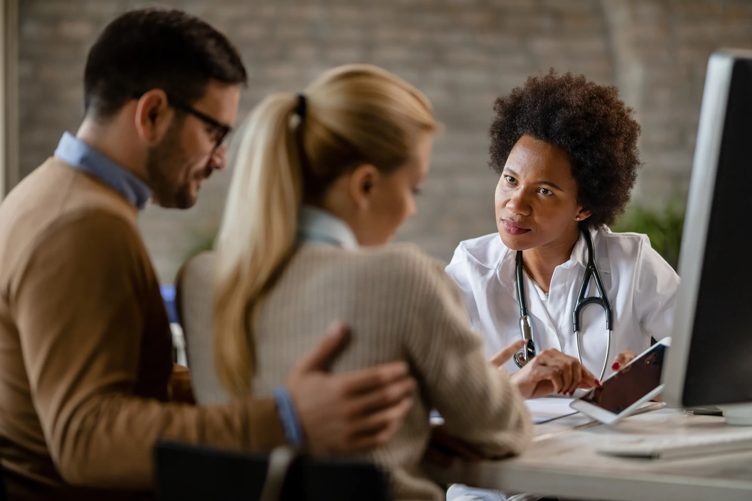 Casal conversa com médica durante atendimento sobre internação compulsória e curatela.